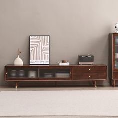 a living room scene with focus on the entertainment center and sideboard in the foreground