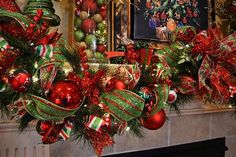 a fireplace mantel decorated for christmas with red, green and gold ornaments on it