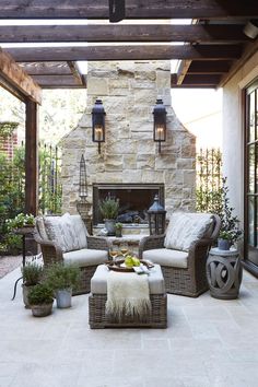 an outdoor living room with couches, tables and lamps on the ceiling is featured in this instagram