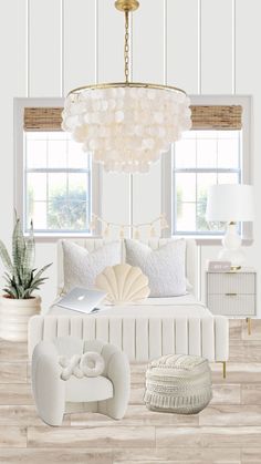 a bedroom with white walls and wood flooring, a chandelier above the bed