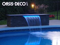 a blue pool with a waterfall in it and the words oasis - deco above it