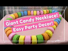 there is a pink sign that says giant candy necklace easy party decor on the table