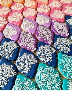 many decorated cookies are displayed on a table