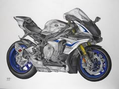 a drawing of a blue and white motorcycle on a white paper with the words yamaha written below it