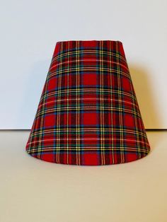 a red plaid lamp shade sitting on top of a table