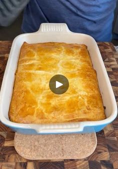 a square casserole dish on a cutting board with a video player in the background