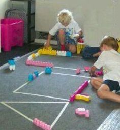 two children playing with toys on the floor