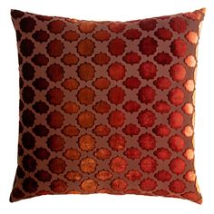 an orange and brown pillow with circles on it's side, against a white background