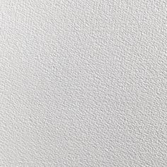 a white textured wallpaper background with some small dots on the bottom and top