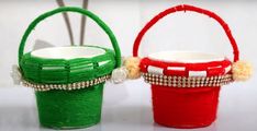 two red and green baskets sitting next to each other on top of a white table