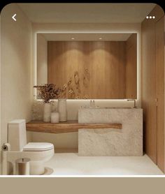 a white toilet sitting next to a wooden shelf in a bathroom under a light fixture