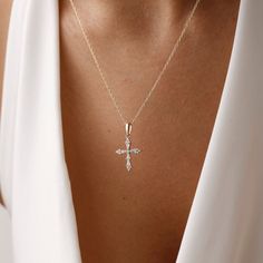 Add dainty to your combinations with our elegant Cross Necklace. Crafted with precision and care, this necklace features a delicate cross pendant adorned with sparkling pave crystals. The elegant design adds a subtle yet stylish accent to any outfit, making it perfect for everyday wear or special occasions. Made from high-quality materials, including durable metal and sparkling crystals, this necklace is designed to last. Its adjustable chain ensures a comfortable fit for everyone, while its tim Elegant Cross Pendant Necklace With Clavicle Chain, Elegant Cross Charm Necklace With Adjustable Chain, Elegant Cross Necklace With Delicate Chain For Gift, Delicate Cross Necklaces For Weddings, Elegant Cross Necklace With Delicate Chain, Elegant Cross Necklace With Adjustable Chain, Delicate Cross Jewelry For Wedding, Delicate Cross Necklace For Wedding, Dainty White Gold Cross Necklace