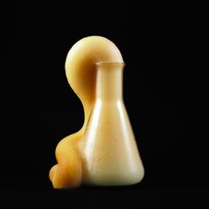 a yellow vase sitting on top of a black table