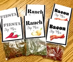 three bags of bacon dip mix sitting on top of a wooden table next to each other