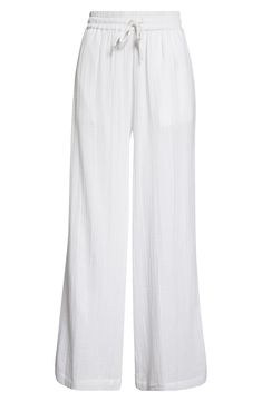 Cut from soft cotton gauze, these cover-up pants feature handy pockets and an easy-fitting drawstring waist. 29" inseam; 27 1/2" leg opening; 13 1/2" front rise; 18" back rise (size Medium) Drawstring waist Side-seam pockets 100% cotton Machine wash, line dry Imported Summer Wide Leg Cotton Pants For Daywear, White Cotton Pants For Beach Season, Beach Wide Leg Cotton Pants, White Beachwear Pants With Elastic Waistband, Cotton Beachwear Pants, Chic Cotton Beach Pants, Cotton Wide Leg Bottoms For Beach Season, Chic Cotton Pants For Beach Season, Wide Leg Cotton Bottoms For Beach Season