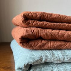 three blankets stacked on top of each other