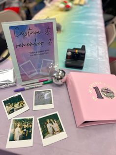 a table topped with pictures and photos next to a pink folder on top of a purple table cloth