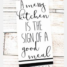 a sign that says, a messy kitchen is the sign of a good meal on it