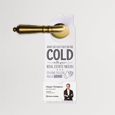 a door hanger with a gold colored handle on it's front and back