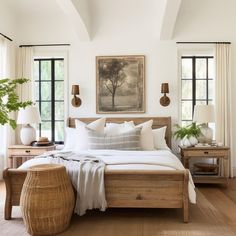 a bed with white sheets and pillows in a bedroom