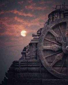 the sun is setting behind a large clock tower with intricate carvings on it's face