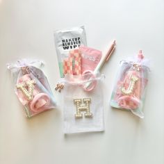 three bags filled with personal items on top of a white table next to each other