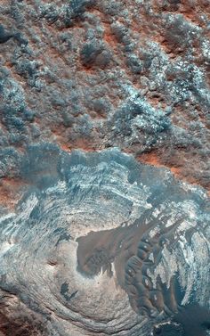 an aerial view of the earth's surface with water and dirt on it,