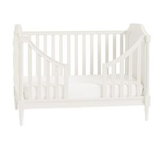 a white crib with no sheets on it