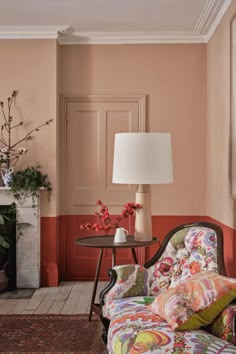 a living room with pink walls and furniture