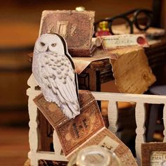 an owl figurine sitting on top of a wooden chair next to other items