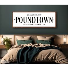 a bed with pillows and blankets in front of a sign that reads, welcome to poundtown population since 2010