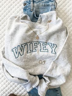 "*Model sample shown with French Blue thread on Ash sweatshirt (model size 4, wearing small)* Hey you WIFEY! The cutest wifey sweatshirt with our oversized Athletic Block font is the perfect addition to that new bride's closet! Perfect as an engagement gift, bachelorette gift, or a treat yourself sweatshirt! - Unisex sizing. - 50% cotton / 50% Polyester - Air jet yarn , softer feel and reduced pilling **NOT PROVIDING ALL OF THE REQUIRED INFORMATION FOR PERSONALIZATION WILL DELAY YOUR ORDER.** Wh Covington Ky, Wifey Sweatshirt, Bride Sweatshirt, New Bride, Womens Sweatshirts, Loungewear Sets, French Blue, Gift For Wife, Fall Shopping