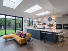 an open kitchen and living room with large windows