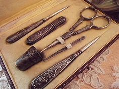 an assortment of antique scissors on display in a case