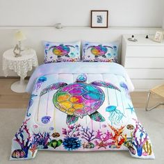 a bed with an ocean themed comforter and pillows