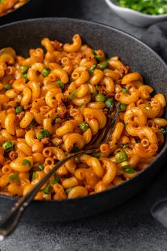 a skillet filled with macaroni and peas