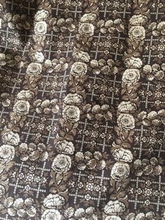 the fabric is brown and white with flowers on it