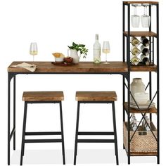 a wooden table topped with two stools next to a shelf filled with bottles and glasses