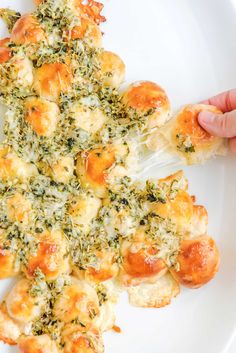 a white plate topped with cheesy bread covered in cheese and broccoli