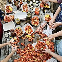 several people sitting at a picnic table eating food