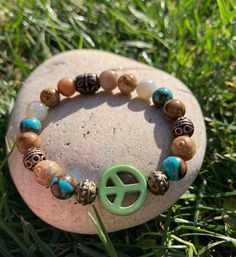 Green Peace Sign surrounded by Turquoise Siderolite, Jasper, Natural Agate, & Metallic Metal Beads.  Such an earthy 🌍 bracelet.  Made with super strong stretch elastic for easy on/off removal.  Can 🐝 worn alone or stacked.  Handmade with Love  💚☮️ Please note: Contains small parts, not recommended for children 0-3. Children over this age should be supervised if wearing. Bohemian Hypoallergenic Beaded Bracelets, Turquoise Hippie Bracelets As Gift, Turquoise Hippie Bracelets For Gifts, Green Peace Sign, Peace Sign Bracelet, Green Peace, Womens Bracelet, Earthy Jewelry, Buddha Bracelets