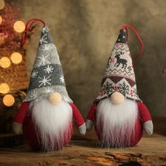 two christmas gnomes sitting next to each other