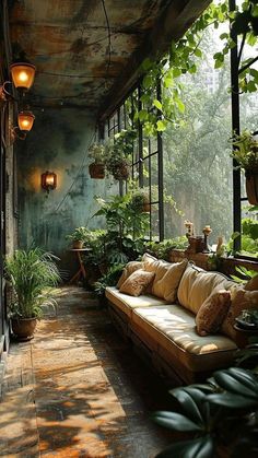 a couch sitting on top of a wooden floor covered in plants