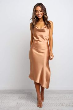 a woman wearing a tan satin slip dress