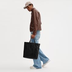 Our Hall is made for doing it all (just like you). Crafted of our pliable lightest weight leather with a soft feel this open top carryall has a durable fabric lining a zip pocket to keep essentials secure and space for a 16 laptop. Finished with our Signature hardware it features both slim shoulder straps and top handles for versatile wear. (Tote it your way.) | Coach Hall Tote Bag - Black Large Sac De Jour Men’s Replica, Men With Tote Bags, Men’s Bags, Coach Bag Men, Tote Bag Men, Office Ootd, Tote Bag For Men, Mens Tote Bag, Tote Bag Outfit