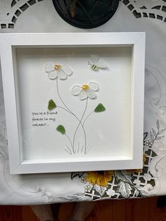 a white frame with some flowers in it