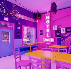 the inside of a brightly colored restaurant with tables and chairs