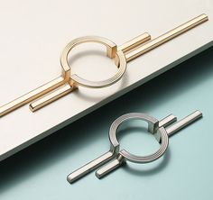 a pair of metal rings sitting on top of a white table next to a laptop