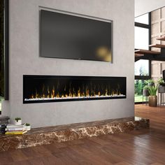 a modern fireplace with a flat screen tv above it and wood flooring in the background