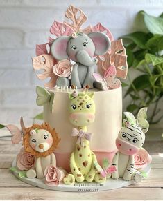 there is a cake decorated with animals and flowers